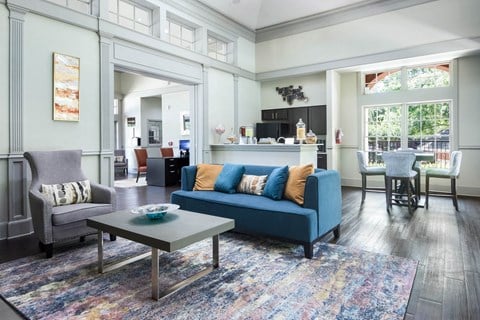 a living room with a blue couch and a coffee table