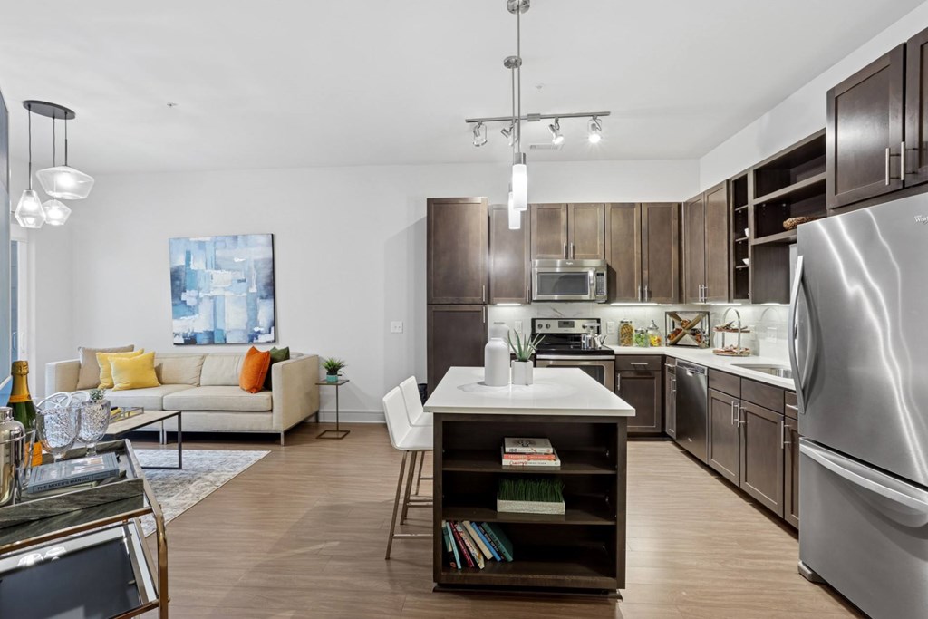 A modern kitchen with a refrigerator, microwave, dishwasher, and oven at Knox Heights Apartments in Dallas, TX