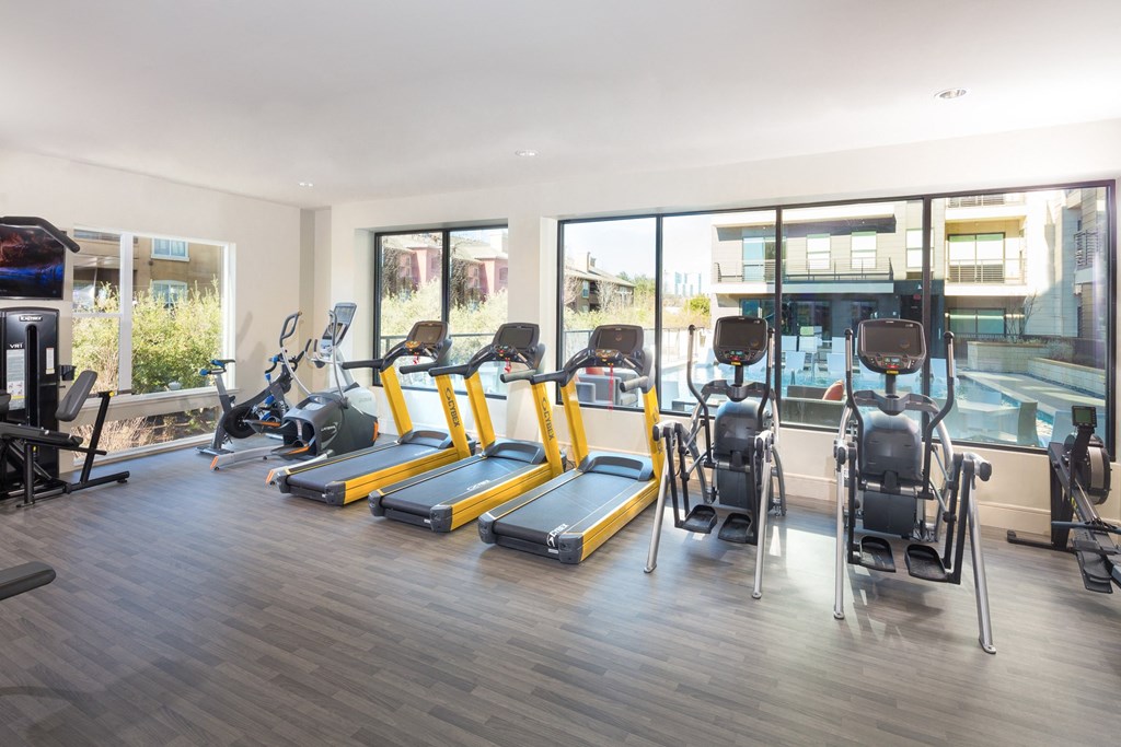 fitness center with treadmilols and elipticals at Knox Heights in Dallas, TX