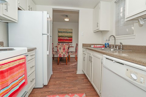 A kitchen with a white refrigerator and a white oven at Laurel Parc apartments in Shreveport, LA.