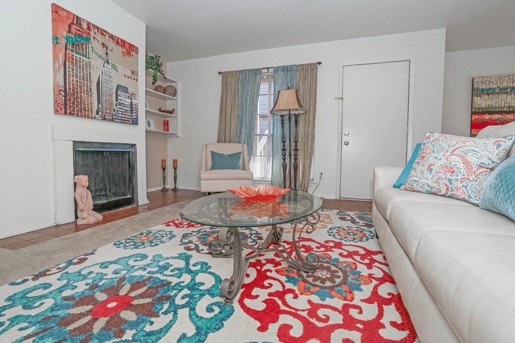 Large model living room with a white couch and a glass coffee table at Laurel Parc apartments in Shreveport, LA.