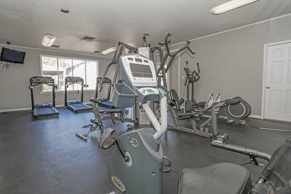 A gym with treadmills, exercise bikes, and other equipment at Laurel Parc apartments in Shreveport, LA.