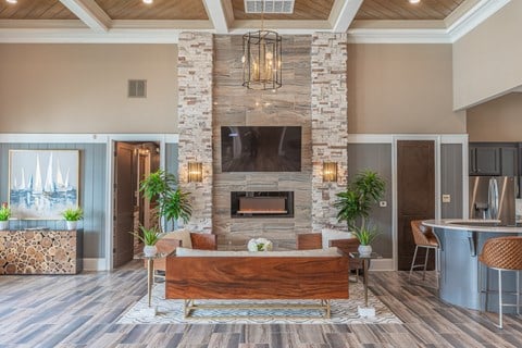 a living room with a stone fireplace and a wooden table