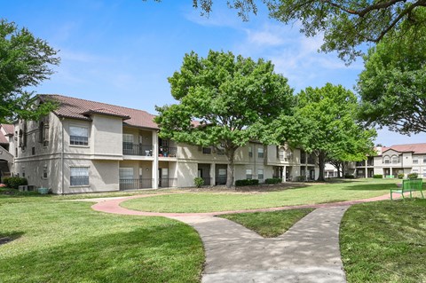 Walking paths along the apartment buildings at La Costa in Plano, TX
