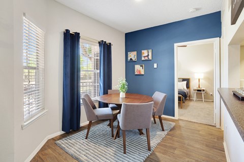 a dining room with a table and chairs