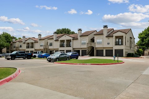 A large building with a parking lot in front of it.
