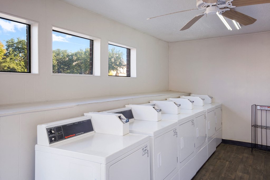 the laundry room has plenty of washes and dryers and a ceiling fan