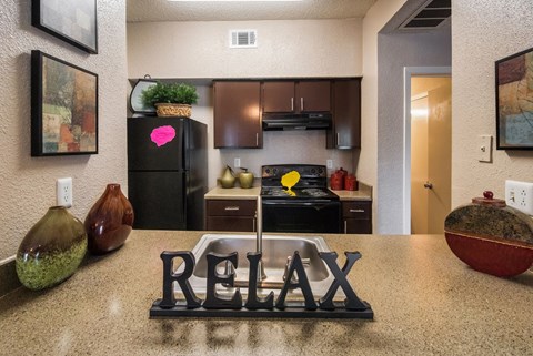 a kitchen with a sink and a refrigerator