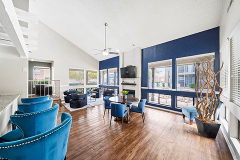 a living room with blue chairs and a table