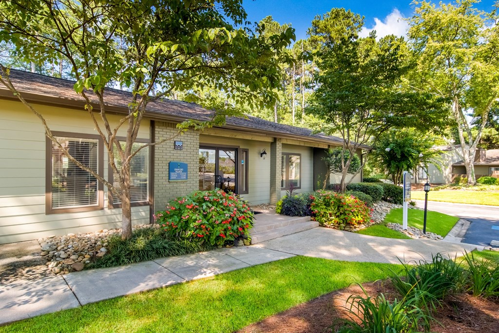 the front of a house with a sidewalk and trees