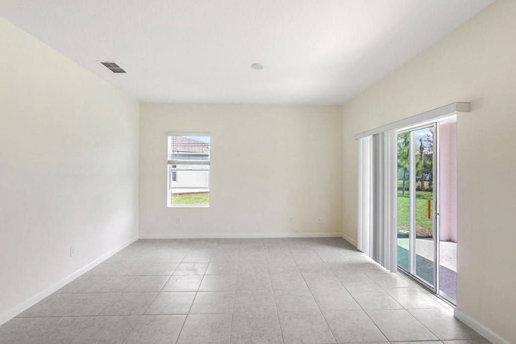 a living room with white walls and a sliding glass door