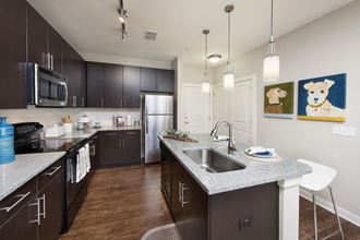 kitchen with stainless steel appliances and granite counter tops at the preserve at polo ridge