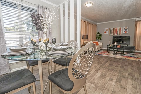 A dining room in our model apartment with a glass table and chairs at Maplewood apartments in Shreveport, LA.