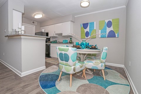 A cypress dining room with a table and chairs in the middle of the room at The Marq in Shreveport, LA