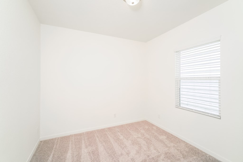 a bedroom with white walls and a window with a blind at Beacon at Meridian, Texas, 78245
