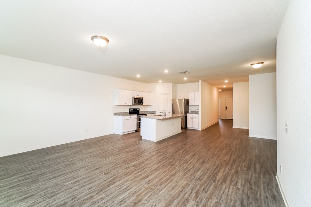 a kitchen and living room in a 555 waverly unit at Beacon at Meridian, San Antonio, 78245