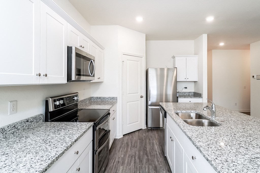 Magnolia kitchen with stainless steel appliances and island at Beacon at Ashley River Landing in Summerville, SC