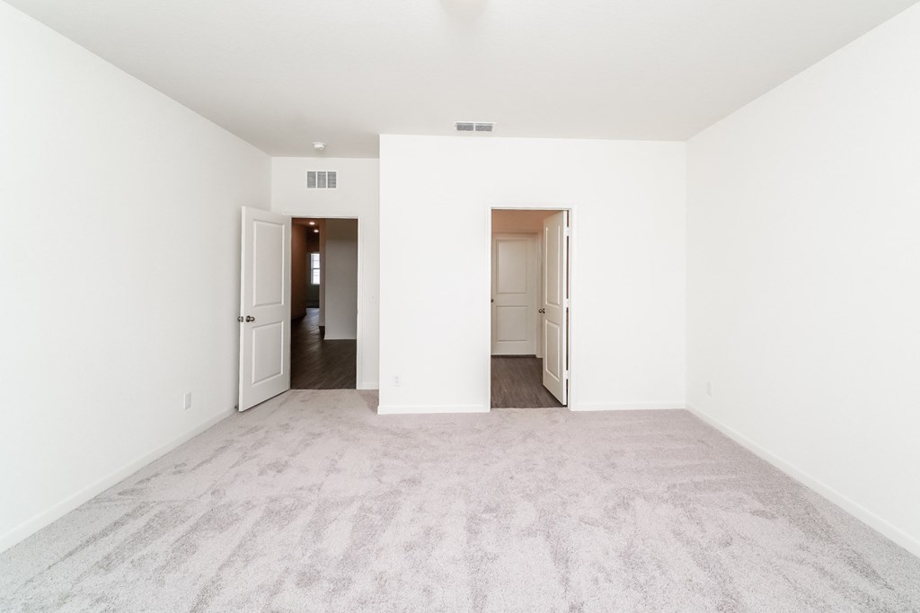 Magnolia master bedroom view out to entryway and bathroom at Beacon at Ashley River Landing in Summerville, SC