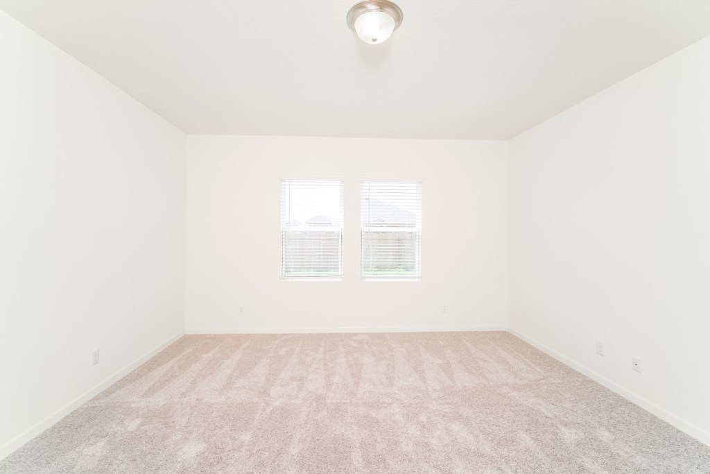 a bedroom with white walls and carpet at Beacon at Meridian, Texas, 78245