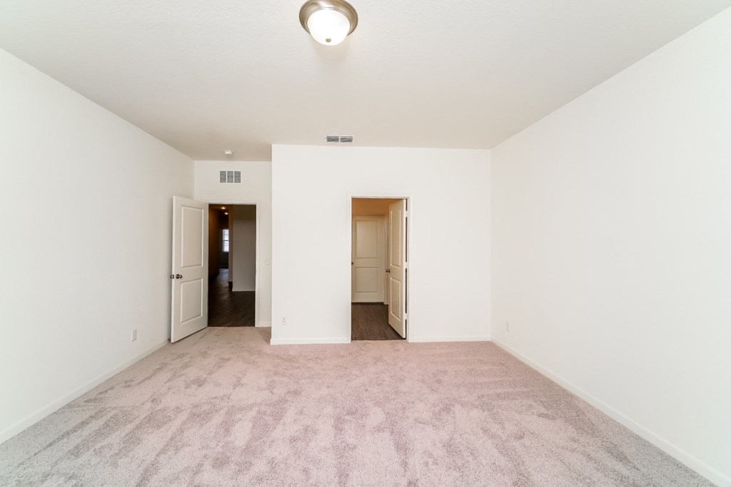 a bedroom with white walls and carpet at Beacon at Meridian, San Antonio Texas