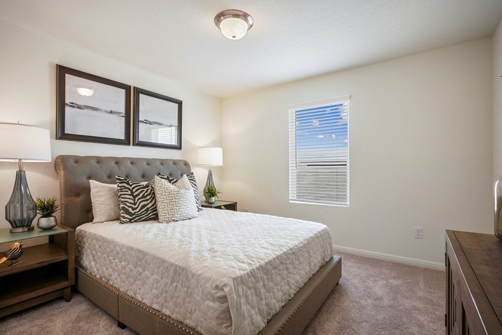 Maple model bedroom with a large bed and a window at Beacon at Ashley River Landing in Summerville, SC
