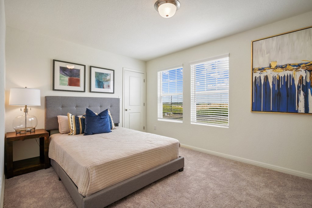 Maple bedroom with a bed and two windows at Beacon at Ashley River Landing in Summerville, SC