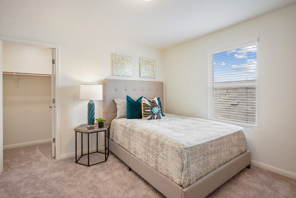 Maple model bedroom with a bed and a window at Beacon at Ashley River Landing in Summerville, SC