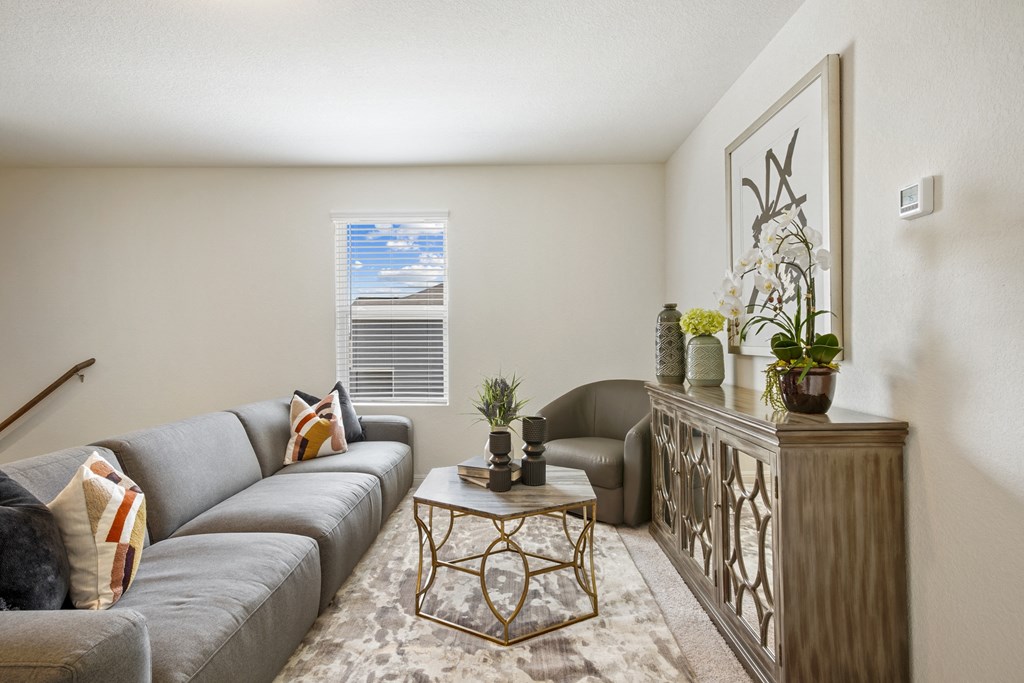 Maple model upstairs loft with a gray couch and a coffee table at Beacon at Ashley River Landing in Summerville, SC