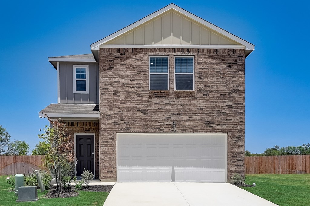 a home with a white garage door at Beacon at Meridian, San Antonio