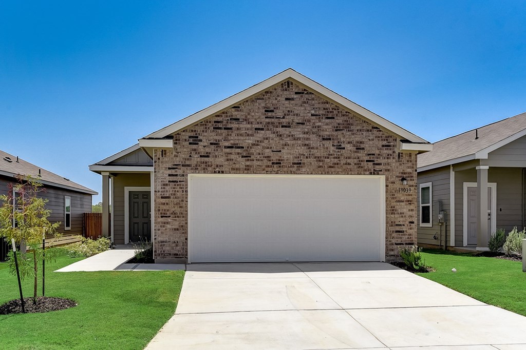 a home with a white garage door at Beacon at Meridian, Texas