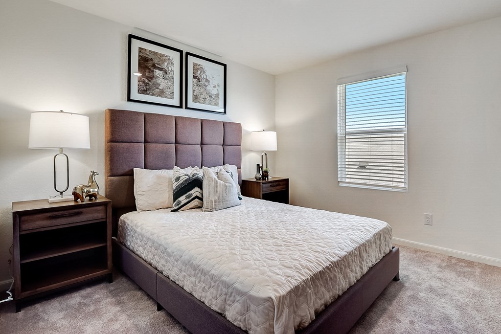 a bedroom with a large bed and two nightstands at Beacon at Meridian, San Antonio