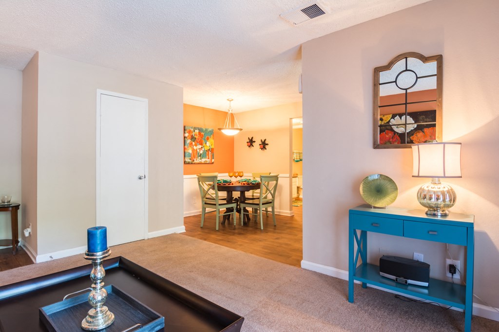a living room with a blue cabinet and a dining room table at Dunwoody Pointe in Sandy Springs, GA