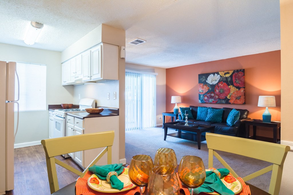 a living room with a dining room table and a kitchen at Dunwoody Pointe in Sandy Springs, GA