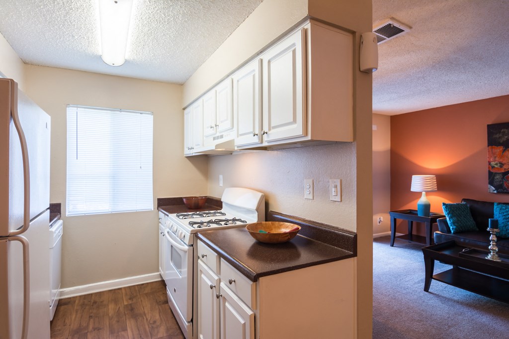 a kitchen with white cabinets and a stove and a refrigerator at Dunwoody Pointe in Sandy Springs, GA