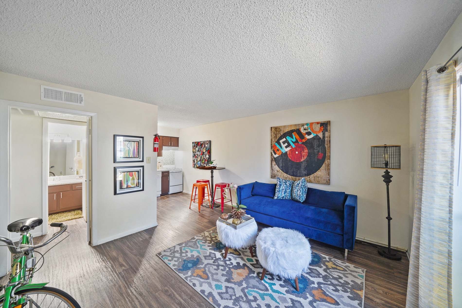 a living room with a blue couch and a rug