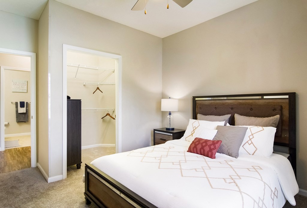 a bedroom with a large bed and a closet