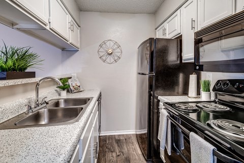 Model Kitchen with Upgraded Black Appliances at The Park on Preston in Dallas, Texas, TX
