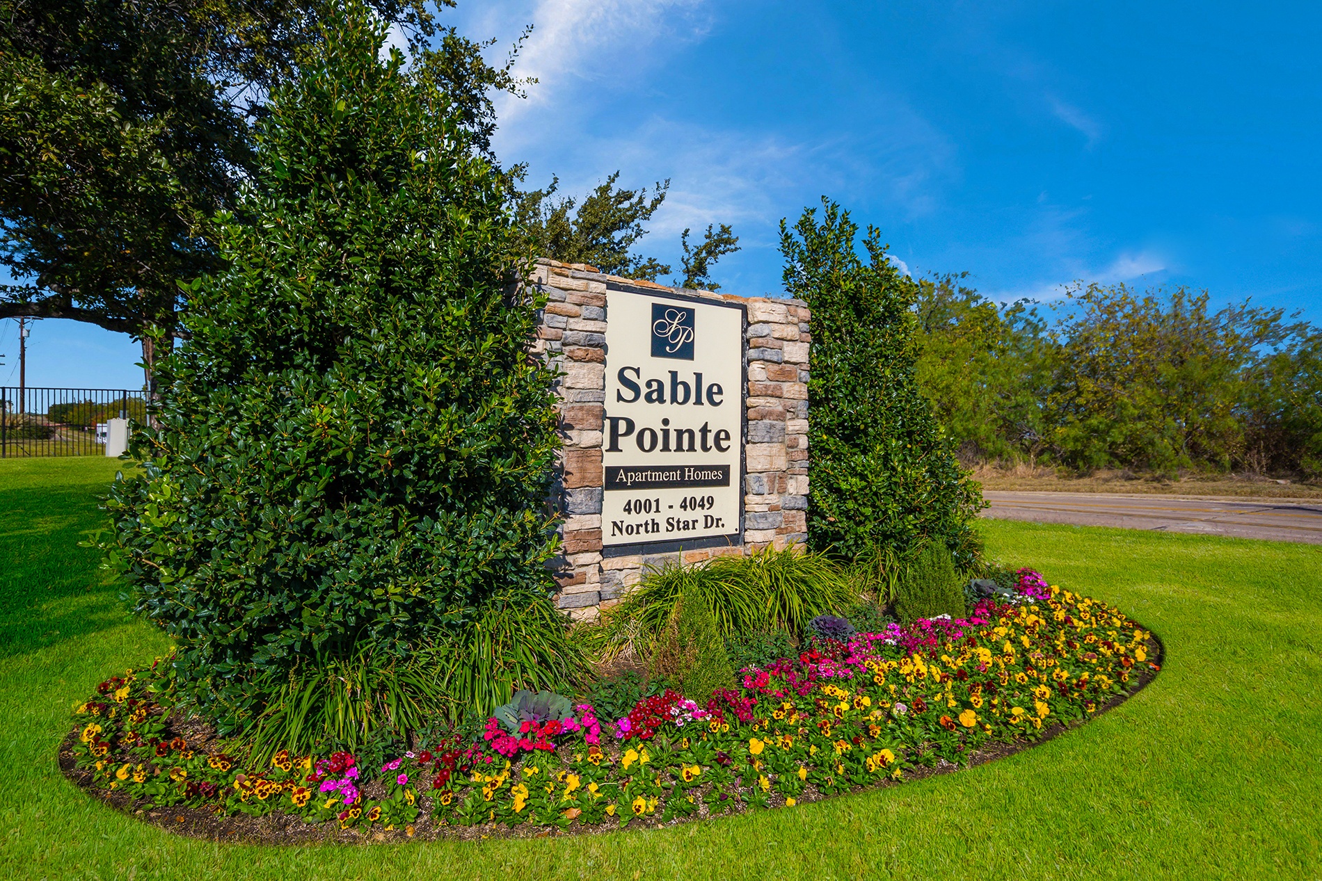 a sign that says saddle pointe with a bunch of flowers in front of it