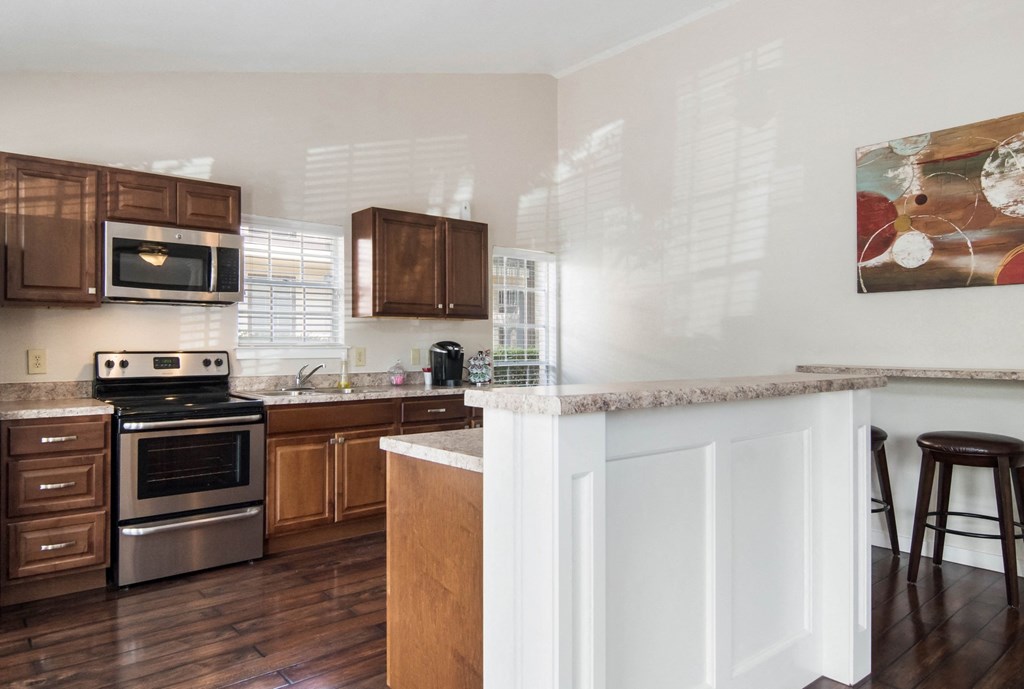 a kitchen with wooden cabinets and stainless steel appliances