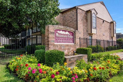 the preserve at mountain ridge apartments sign in front of flowers