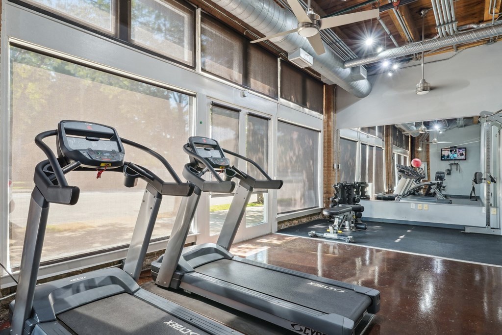 Murray Building gym with cardio equipment, free weights, and multi-use cable machine | Deep Ellum Lofts in Dallas, TX