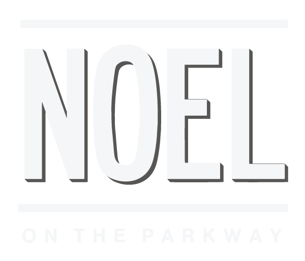 A green sign with the word "NOEL" in large white letters and "ON THE PARKWAY" in smaller white letters below it.