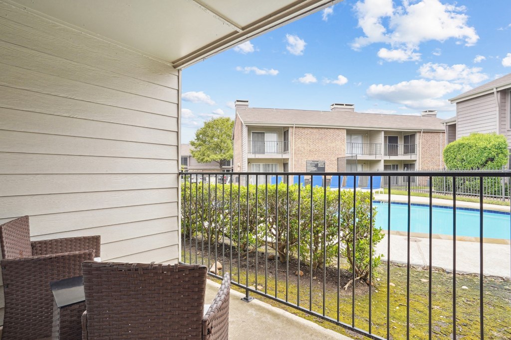 Model A2 floor plan balcony with chairs and view of the pool Noel on The Parkway in Dallas, TX