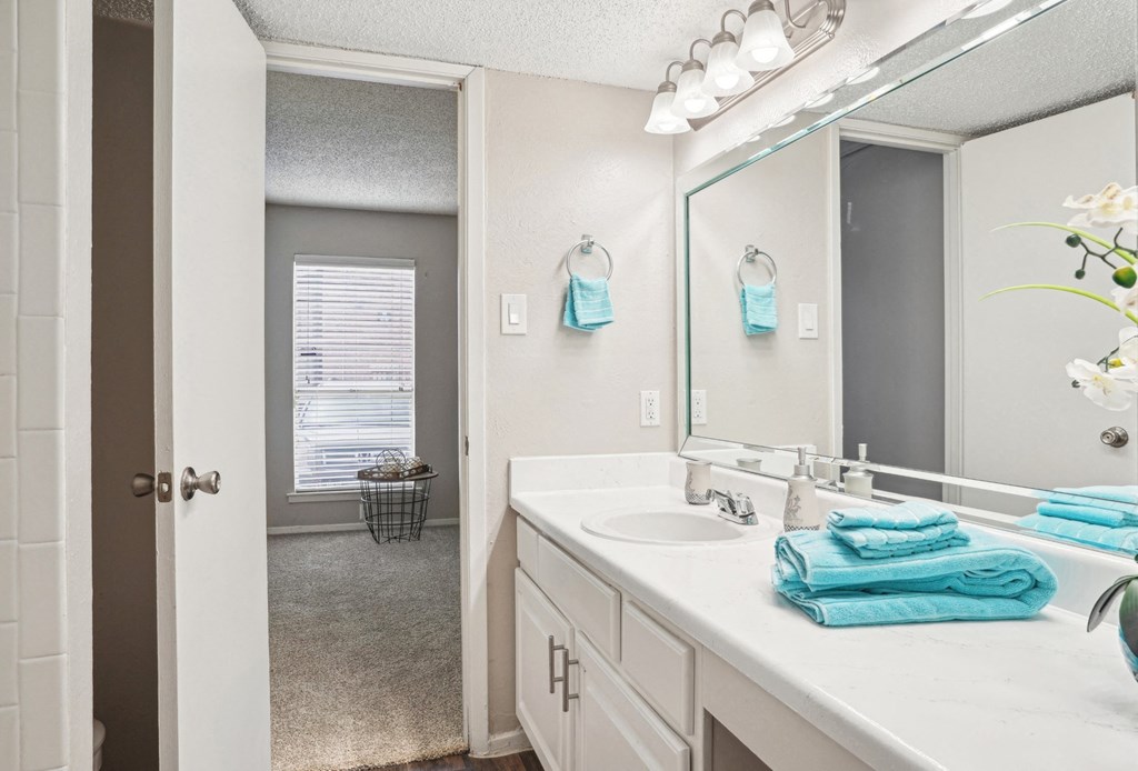 Model A2 floor plan bathroom with a sink and a mirror Noel on The Parkway in Dallas, TX