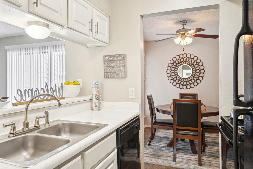 Model A2 floor plan kitchen and dining room with a sink and a ceiling fan at Noel on the Parkway in Dallas, TX