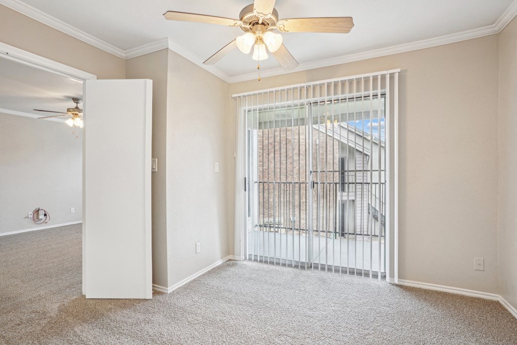 Unfurnished A4 floor plan living room with a door leading to balcony and a ceiling fan Noel on The Parkway in Dallas, TX