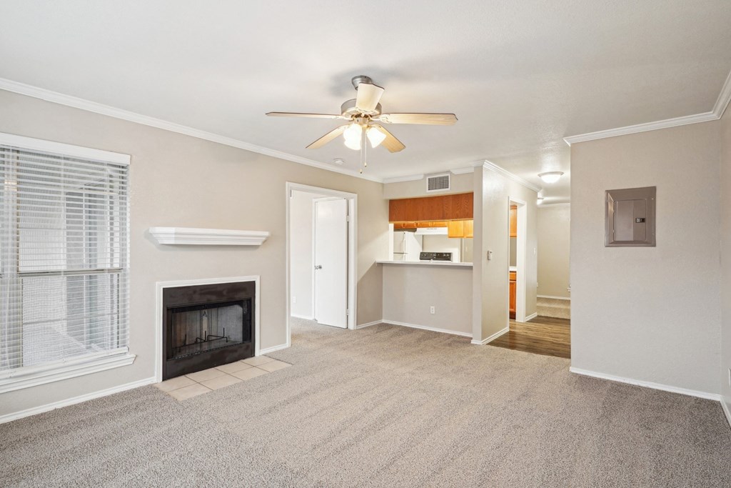Unfurnished A4 floor plan living room with a fireplace and mantel, ceiling fan, and window Noel on The Parkway in Dallas, TX