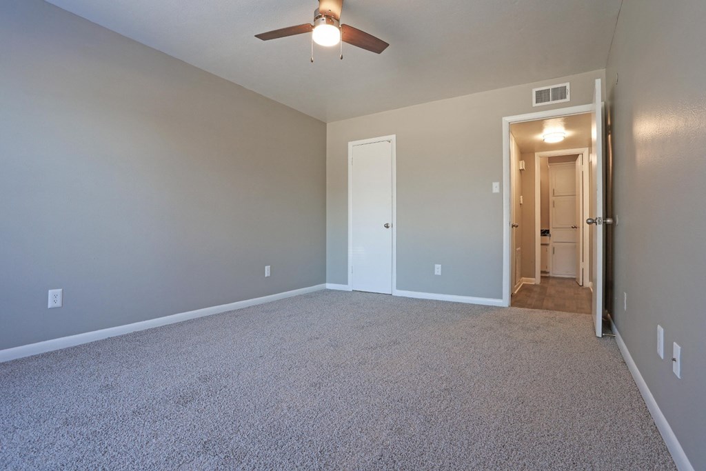 A bedroom with a ceiling fan and closet at Orleans Square in Shreveport, LA