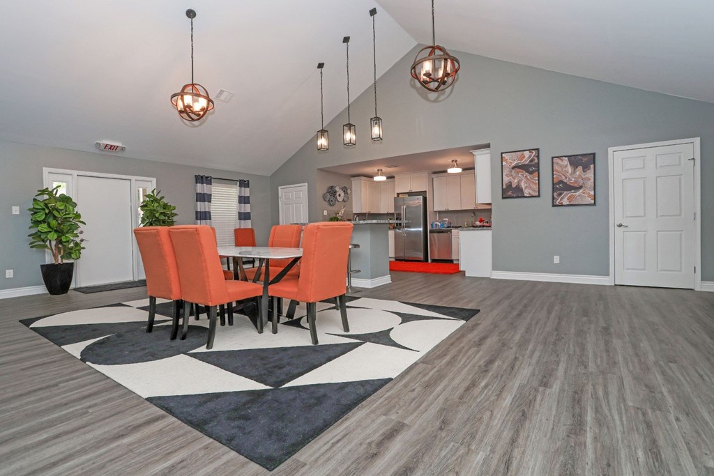Vibrant chairs surround a table in a modern clubhouse at Orleans Square in Shreveport, LA