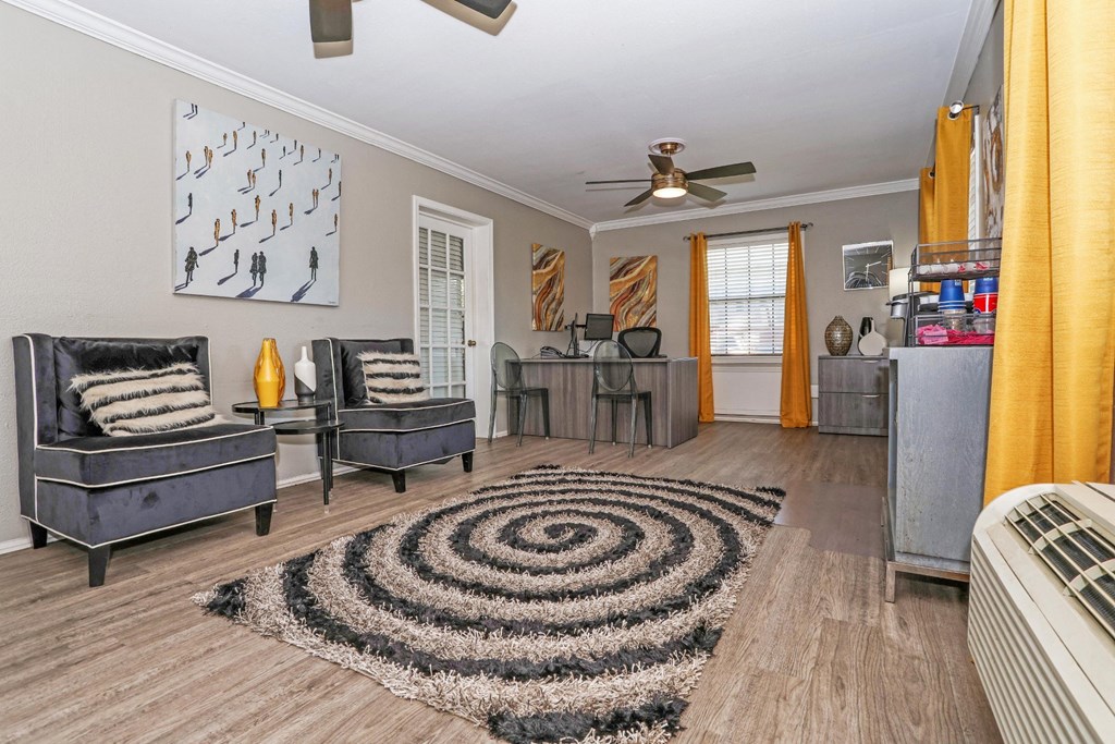 A leasing office with a black and white rug and a ceiling fan at Orleans Square in Shreveport, LA